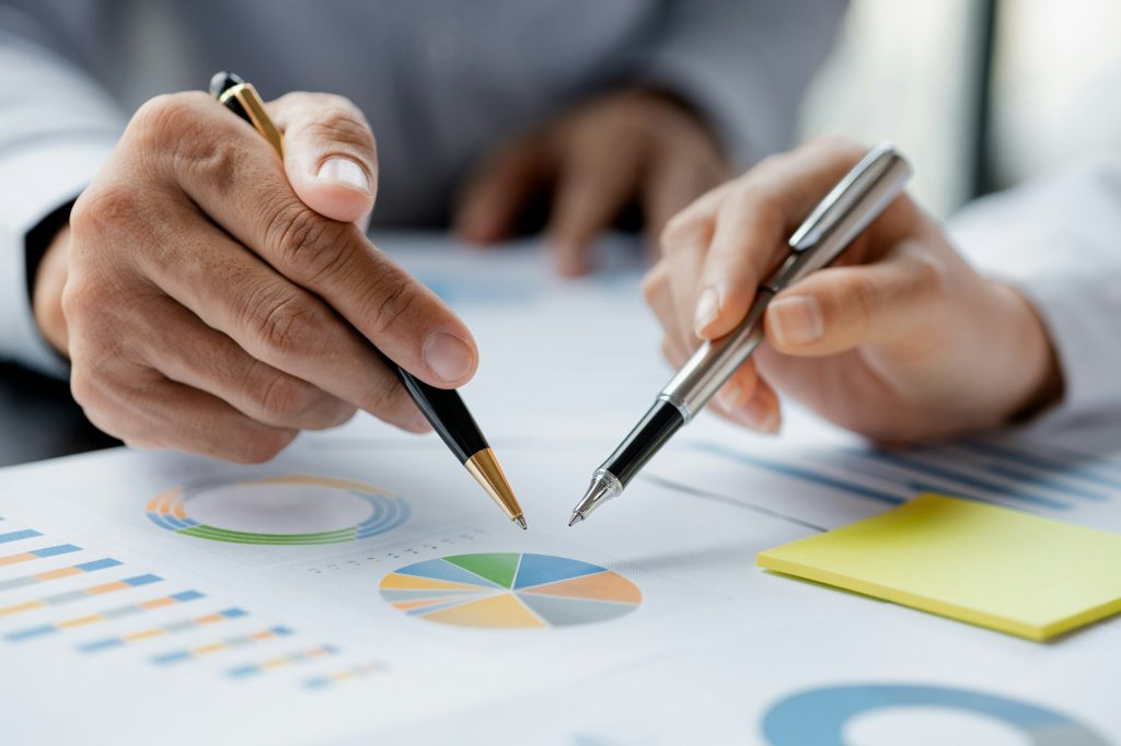 Company meeting room has businessmen and finance managers meeting together on finance topics.